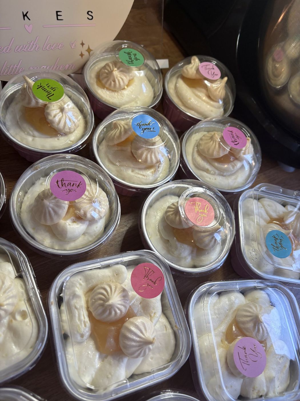Individual lemon meringue cheesecakes topped with lemon curd and torched meringue kisses