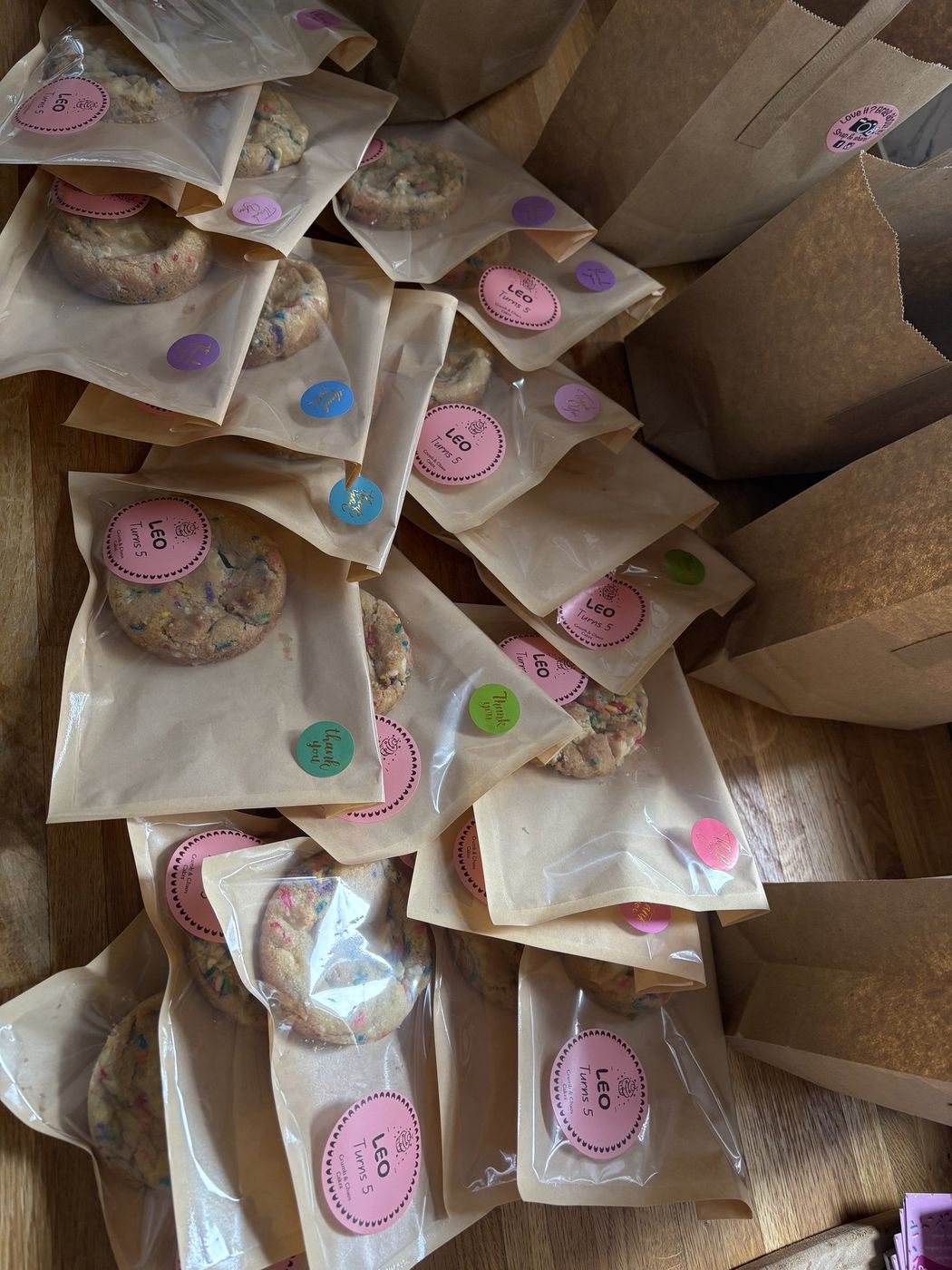 Personalised confetti birthday cookies packaged with Leo Turns 5 stickers