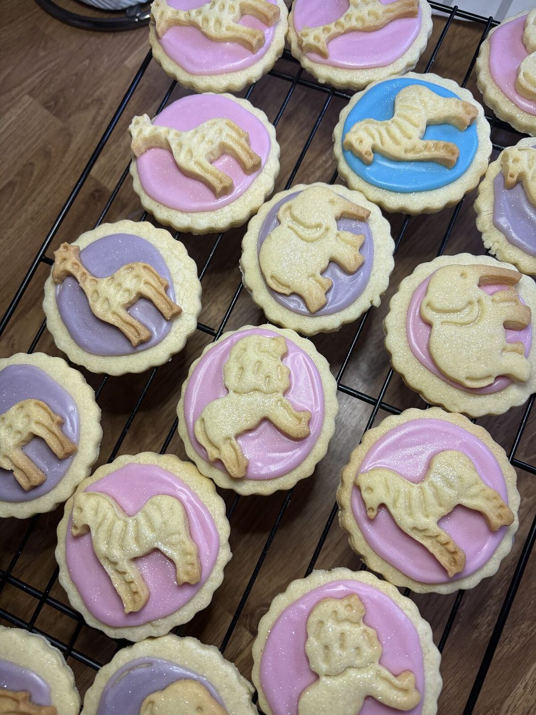 Iced sugar cookies with safari animal cut-outs in pink, lilac and blue