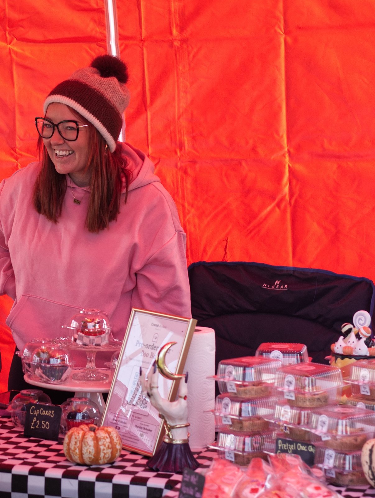 Lauren laughing with customers at the Crumb & Chaos Cakes market stall