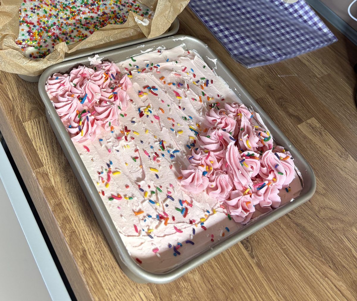 Pink sprinkle tray bake with buttercream swirls
