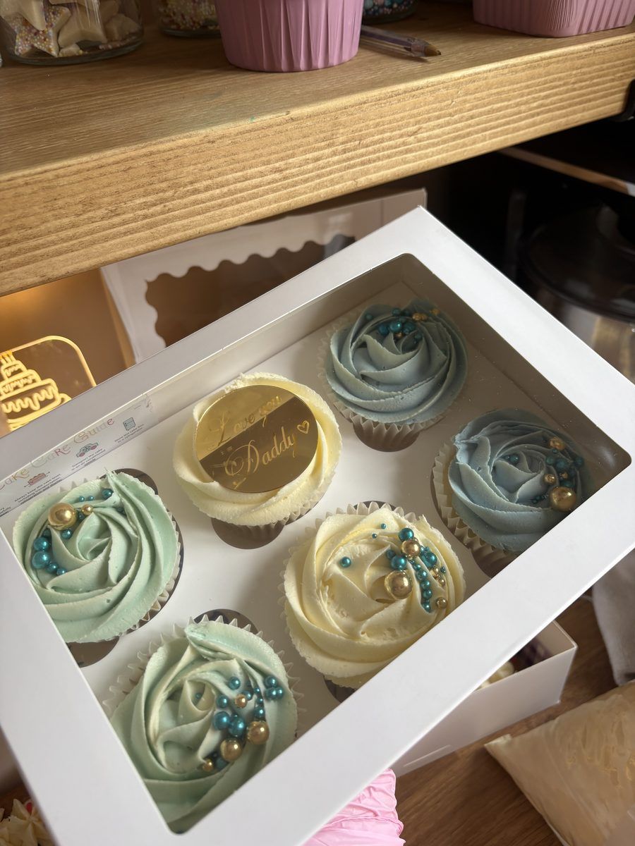 Box of mint and blue rose cupcakes from a Treat Club order